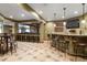 Finished basement bar area with seating, tile flooring, and stylish lighting fixtures at 9009 Rambling Oak Pl, Parker, CO 80134