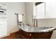 Basement bathroom with a soaking tub, tile floors, and a bright window at 9009 Rambling Oak Pl, Parker, CO 80134