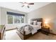 This bedroom features a large window with outdoor views and a ceiling fan at 9009 Rambling Oak Pl, Parker, CO 80134