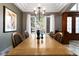 Traditional dining room with a large wood table, view of landscaped front yard, and chandelier lighting at 9009 Rambling Oak Pl, Parker, CO 80134