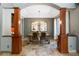 Elegant dining room with architectural pillars, chandelier lighting, and travertine flooring at 9009 Rambling Oak Pl, Parker, CO 80134