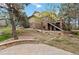 Backyard view showcasing the stone patio and mature trees at 9009 Rambling Oak Pl, Parker, CO 80134