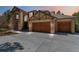 Beautiful home with stone accents and a large driveway leading to the three-car garage at 9009 Rambling Oak Pl, Parker, CO 80134