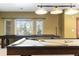 Basement game room featuring a billiards table and a shuffleboard table near a bright window at 9009 Rambling Oak Pl, Parker, CO 80134