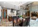 Open-concept kitchen and dining area with a large island and modern lighting fixtures at 9009 Rambling Oak Pl, Parker, CO 80134