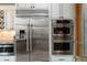 Modern kitchen appliances including a stainless steel refrigerator and double ovens at 9009 Rambling Oak Pl, Parker, CO 80134