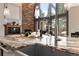 Modern kitchen features granite countertops, a stainless steel faucet, and an open layout near a stone fireplace at 9009 Rambling Oak Pl, Parker, CO 80134