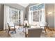 Cozy living room with large windows, comfortable seating, area rug, and great natural light at 9009 Rambling Oak Pl, Parker, CO 80134