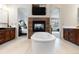An exquisite main bathroom features a fireplace, soaking tub, and dual sink vanities at 9009 Rambling Oak Pl, Parker, CO 80134