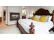 A beautiful main bedroom features a fireplace, ensuite bathroom and a large decorative bed at 9009 Rambling Oak Pl, Parker, CO 80134