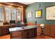 Home office features custom wood millwork, a large desk, shutters, and built-in bookshelves at 9009 Rambling Oak Pl, Parker, CO 80134