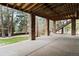 Covered outdoor living area features stone pillars and access to the fenced backyard at 9009 Rambling Oak Pl, Parker, CO 80134