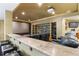 Basement home theater featuring a projector, screen, and tiered seating with a wet bar in the back at 9009 Rambling Oak Pl, Parker, CO 80134