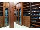 A beautifully designed walk-in closet features a mirror and built in shelving and cabinets at 9009 Rambling Oak Pl, Parker, CO 80134