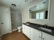 Bathroom features dual sinks, a shower with glass doors, and vinyl flooring at 1943 Meadow Dr # B2, Longmont, CO 80501