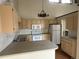 Bright kitchen featuring tiled backsplash, modern appliances, and an island at 1943 Meadow Dr # B2, Longmont, CO 80501