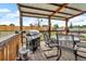 Covered patio features a grill and outdoor dining set, perfect for entertaining in this spacious backyard at 4694 S Ouray Way, Aurora, CO 80015