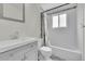 Bright bathroom featuring tiled floors, a shower-tub combo, and a modern vanity with a sink at 4694 S Ouray Way, Aurora, CO 80015