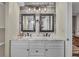 Modern bathroom featuring dual sinks, marble countertops, and contemporary lighting at 4694 S Ouray Way, Aurora, CO 80015