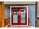 Exterior view of the home's red double door entrance with adjacent porch at 4694 S Ouray Way, Aurora, CO 80015