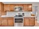 Well-equipped kitchen features stainless steel appliances and stylish cabinetry at 4694 S Ouray Way, Aurora, CO 80015