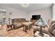 Bright living room boasts hardwood floors, comfortable seating, and a large television at 4694 S Ouray Way, Aurora, CO 80015