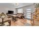 Inviting living room features hardwood floors, a plush sofa, and abundant natural light at 4694 S Ouray Way, Aurora, CO 80015