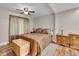 Cozy bedroom with hardwood floors, a ceiling fan, and comfortable furnishings at 4694 S Ouray Way, Aurora, CO 80015