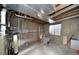 An unfinished basement featuring concrete walls, exposed ductwork, and a small window at 15300 Cavanaugh Rd, Keenesburg, CO 80643