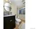 Well-lit bathroom featuring a modern vanity with granite countertop and a window well for ample natural light at 15300 Cavanaugh Rd, Keenesburg, CO 80643