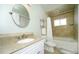 Bathroom featuring bathtub, shower, and tile walls with large mirror over the sink at 15300 Cavanaugh Rd, Keenesburg, CO 80643