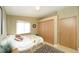 Cozy bedroom featuring natural light, comfortable bed and closet for storage at 15300 Cavanaugh Rd, Keenesburg, CO 80643