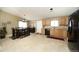 Bright dining area with a wooden table, chandelier lighting, and tile flooring at 15300 Cavanaugh Rd, Keenesburg, CO 80643