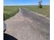 Gravel driveway leading to the property on a sunny day at 15300 Cavanaugh Rd, Keenesburg, CO 80643