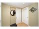Neutral hallway with two white doors, modern decor and a leather ottoman at 15300 Cavanaugh Rd, Keenesburg, CO 80643