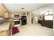 Well-lit kitchen with wood cabinets, tile floors, and open layout connecting to the adjacent living spaces at 15300 Cavanaugh Rd, Keenesburg, CO 80643