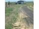 A driveway leading to a shop or garage on a large grassy lot at 15300 Cavanaugh Rd, Keenesburg, CO 80643