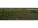 Sprawling grassy field enclosed by a fence line on a large property at 15300 Cavanaugh Rd, Keenesburg, CO 80643
