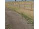 A landscape image featuring an eagle sitting on a fence post at 15300 Cavanaugh Rd, Keenesburg, CO 80643