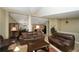Inviting living room with comfortable leather sofas, tiled floor, and an open flow to other living spaces at 15300 Cavanaugh Rd, Keenesburg, CO 80643