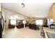 Open-concept living area with tile floors, comfortable seating, and views into dining and kitchen spaces at 15300 Cavanaugh Rd, Keenesburg, CO 80643