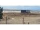 Horses grazing in a fenced pasture with shelter, offering a peaceful rural setting with distant mountains at 15300 Cavanaugh Rd, Keenesburg, CO 80643