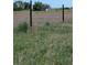 Fenced grassy field with the house in the distance, delineating the property line in a rural setting at 15300 Cavanaugh Rd, Keenesburg, CO 80643