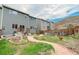 An enchanting backyard with a winding stone path and lush garden, perfect for relaxation and outdoor enjoyment at 1552 Live Oak Rd, Castle Rock, CO 80104