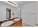 Bathroom featuring double vanity sinks, large mirror, and wood cabinets at 1552 Live Oak Rd, Castle Rock, CO 80104