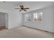 Bedroom with plush carpeting, ceiling fan, and two windows at 1552 Live Oak Rd, Castle Rock, CO 80104