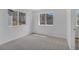 A bright bedroom with two large windows and neutral carpeting at 1552 Live Oak Rd, Castle Rock, CO 80104