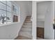 Bright entryway with carpeted stairs and a window letting in natural light at 1552 Live Oak Rd, Castle Rock, CO 80104