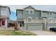 Two-story townhome with a front-facing balcony and green siding at 1552 Live Oak Rd, Castle Rock, CO 80104