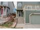 Townhome showcasing a front entry with concrete steps leading to the door and overhead balcony at 1552 Live Oak Rd, Castle Rock, CO 80104